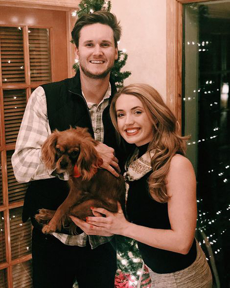 Morgan and boyfriend holding their dog